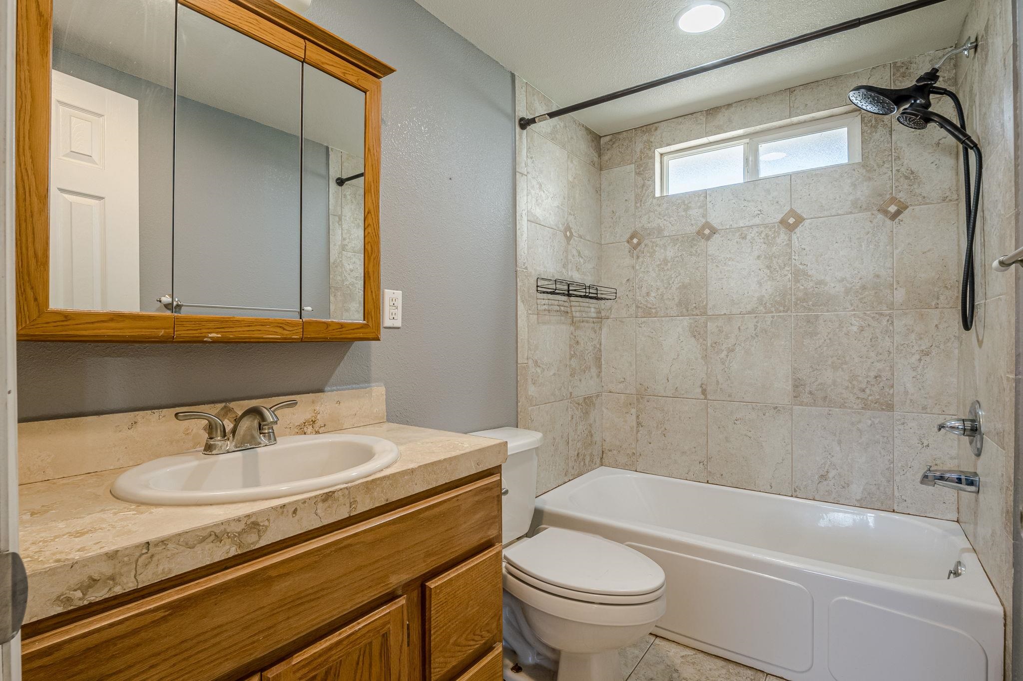585-29 29 3/8 Road Grand Junction, CO 81504 - Photo 24 of 42 a bathroom with a granite countertop sink a toilet and shower