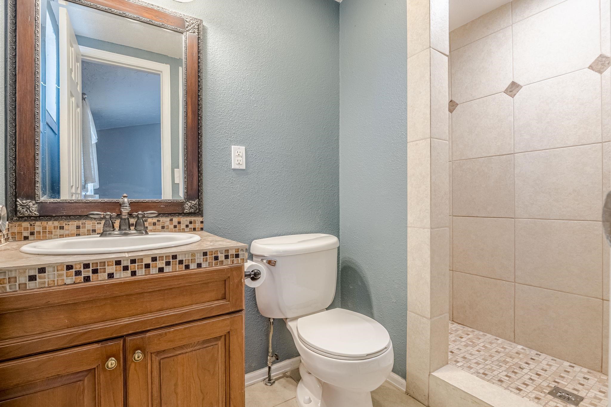 585-29 29 3/8 Road Grand Junction, CO 81504 - Photo 28 of 42 a bathroom with a granite countertop toilet a sink and a mirror
