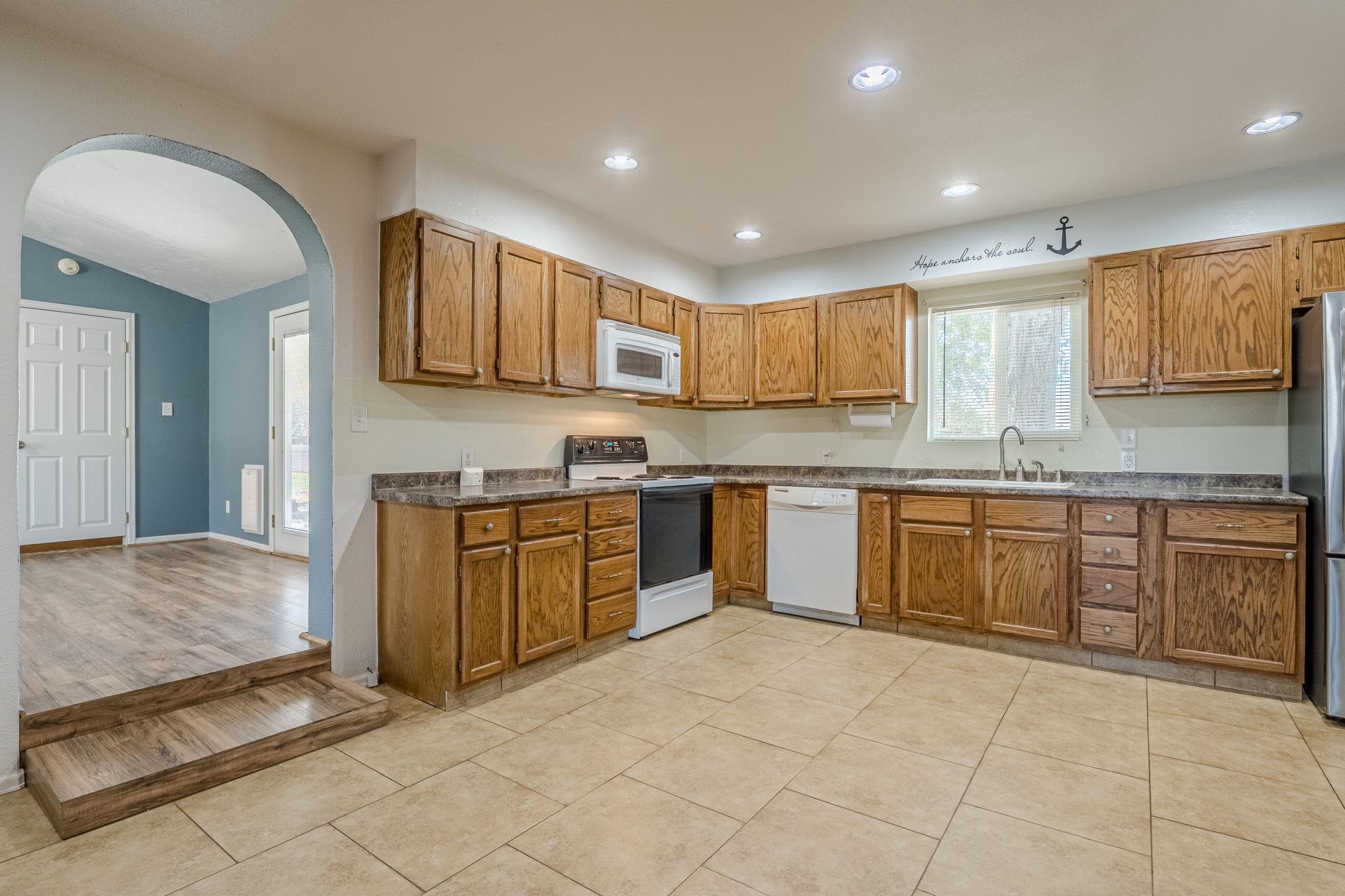 585-29 29 3/8 Road Grand Junction, CO 81504 - Photo 5 of 42 a kitchen with stainless steel appliances granite countertop a stove sink and cabinets