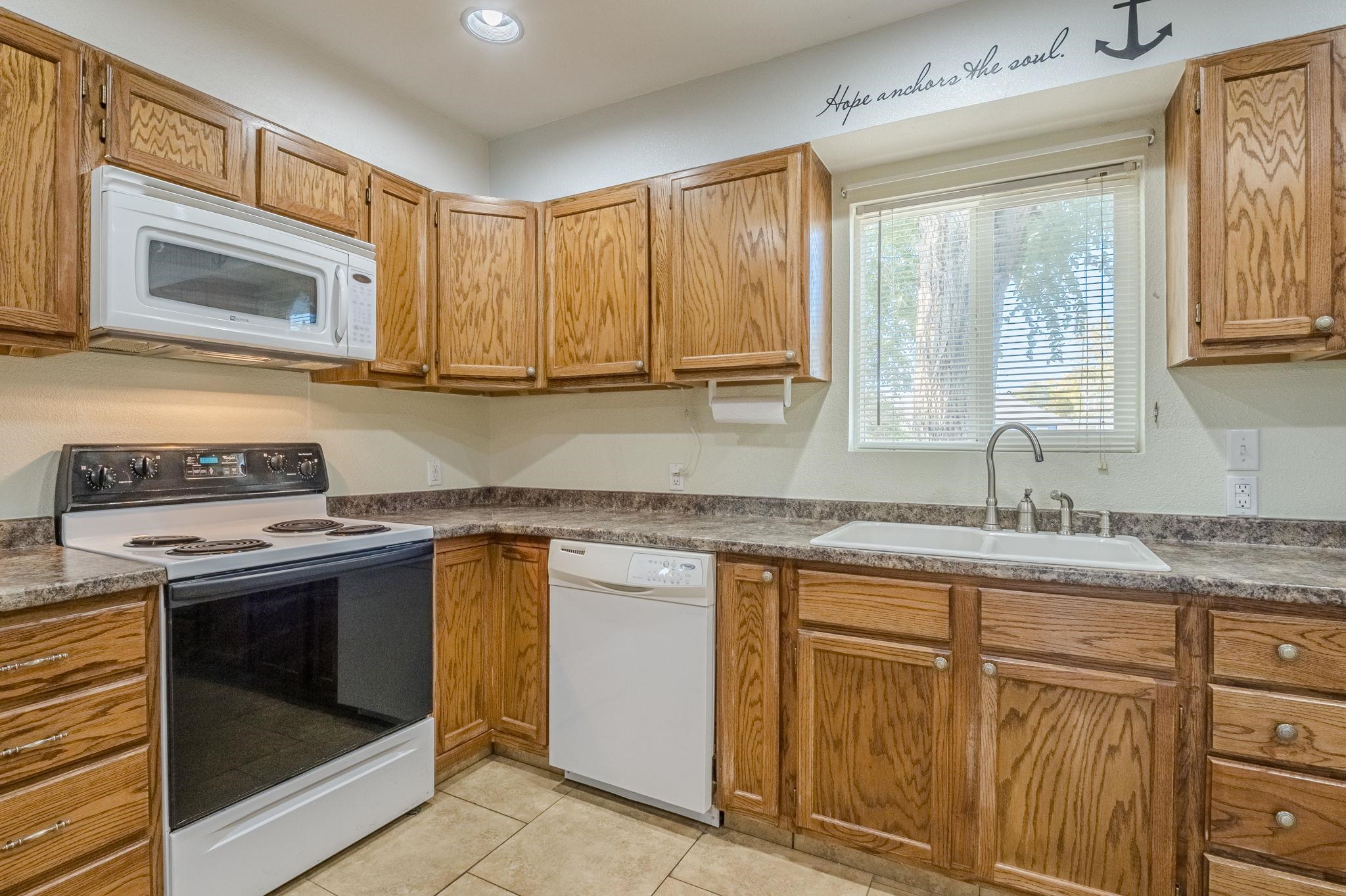585-29 29 3/8 Road Grand Junction, CO 81504 - Photo 6 of 42 a kitchen with stainless steel appliances granite countertop a stove sink and cabinets