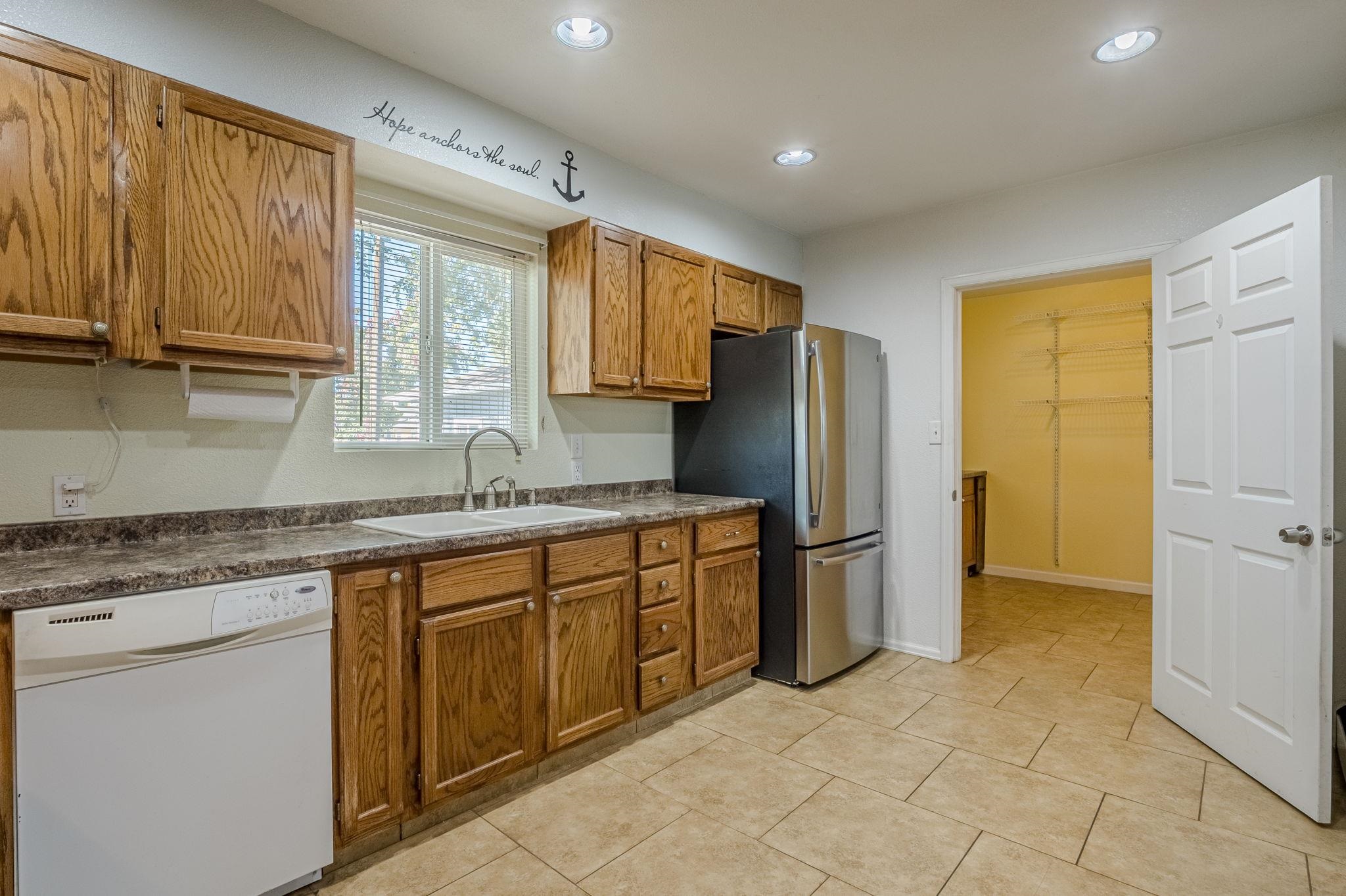 585-29 29 3/8 Road Grand Junction, CO 81504 - Photo 7 of 42 a kitchen with a sink refrigerator and cabinets
