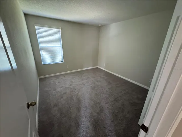 an empty room with a empty space and windows