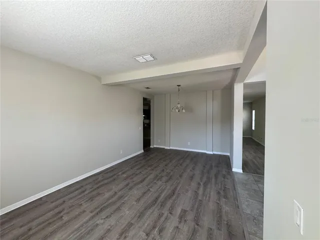 wooden floor in a hall with an empty room