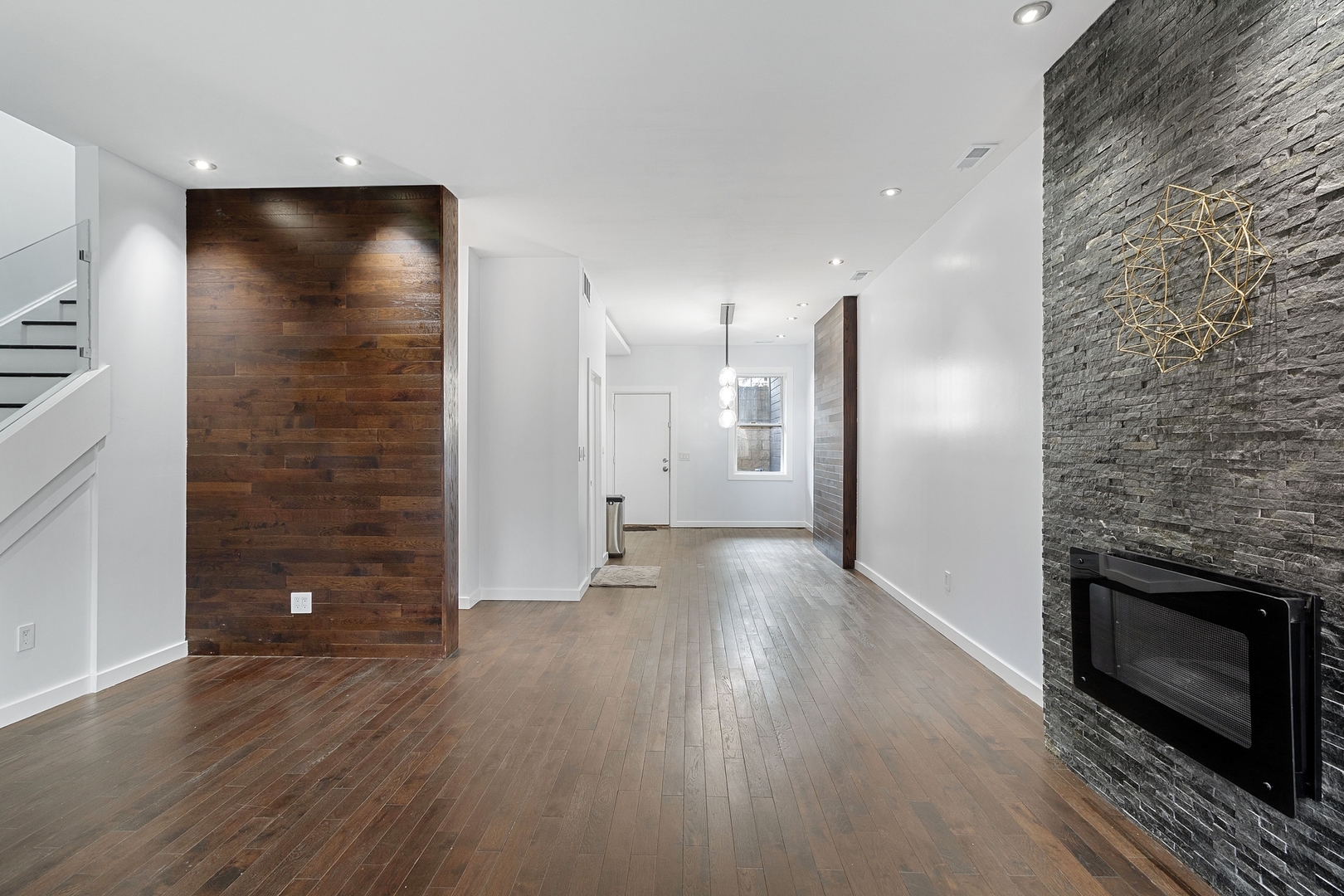 Undisclosed Address Chicago, IL 60607 - Photo 2 of 17 an empty room with wooden floor and fireplace