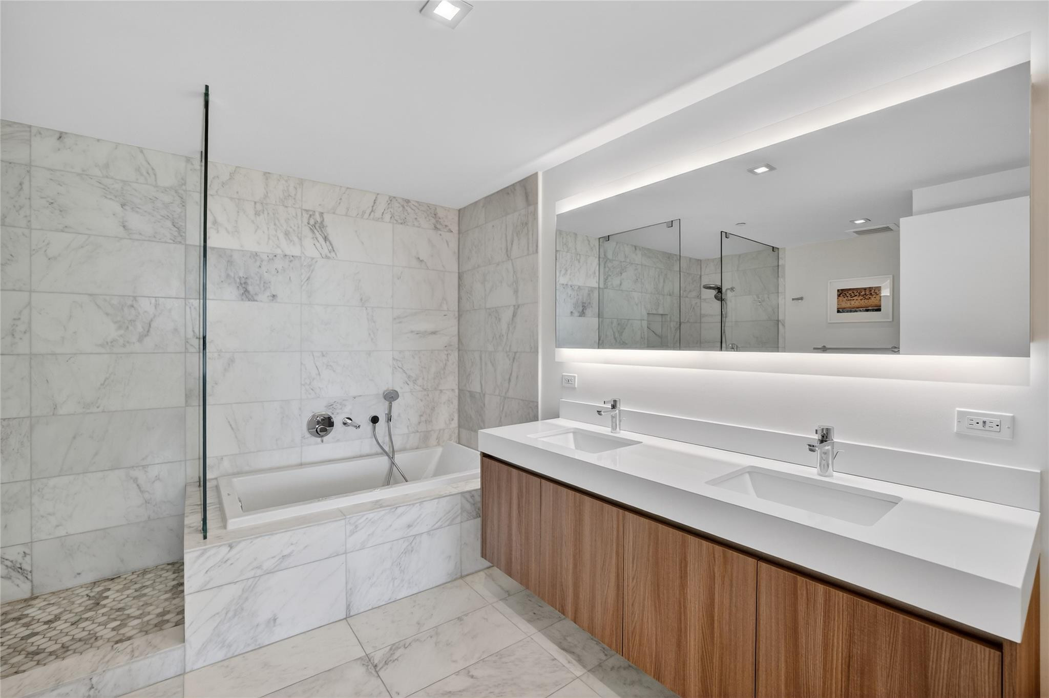 401 North Birch Road, Unit 600 Fort Lauderdale, FL 33304 - Photo 16 of 47 a spacious bathroom with a bathtub shower sink double and mirror