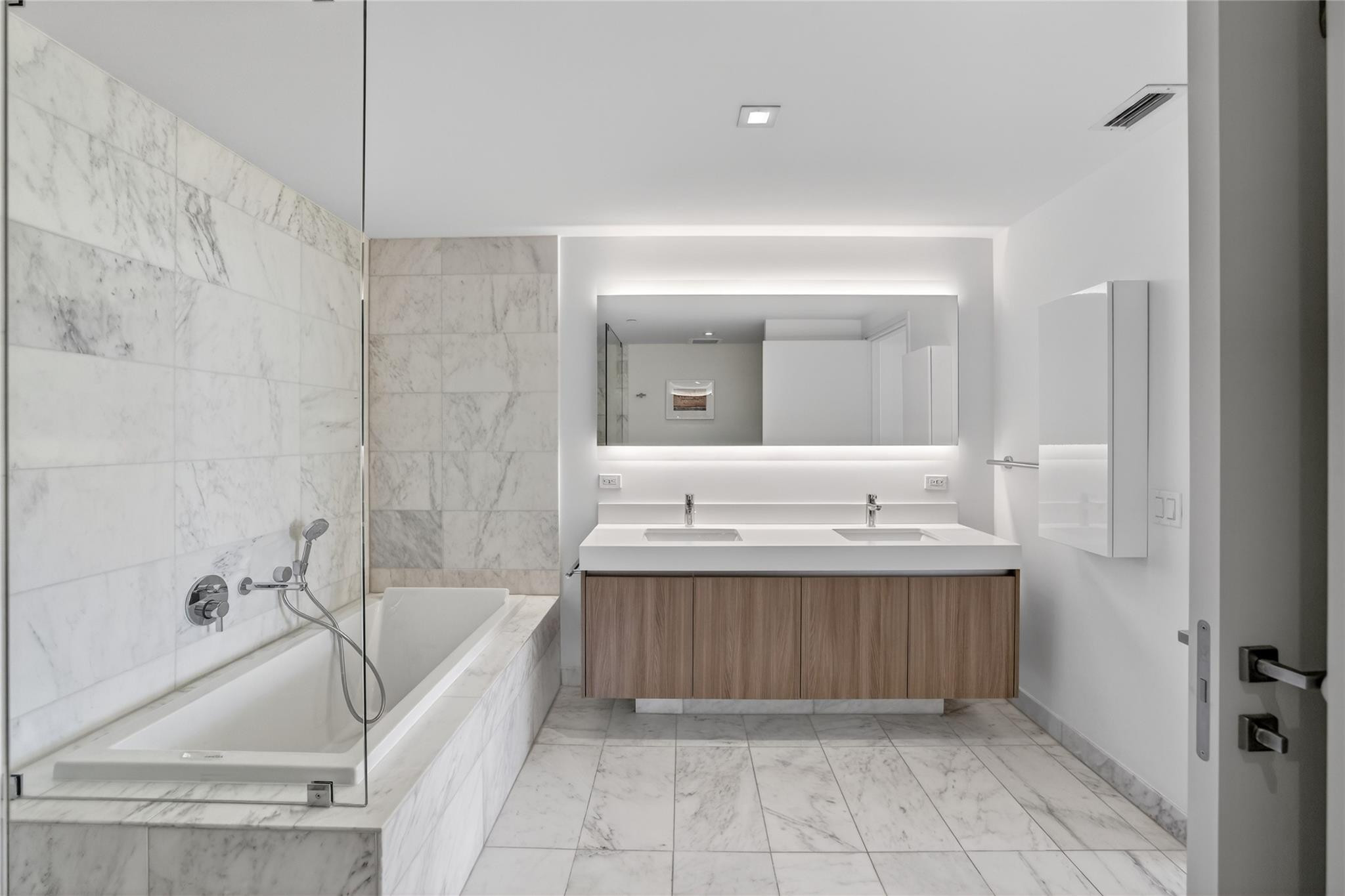 401 North Birch Road, Unit 600 Fort Lauderdale, FL 33304 - Photo 18 of 47 a bathroom with a tub sink and mirror