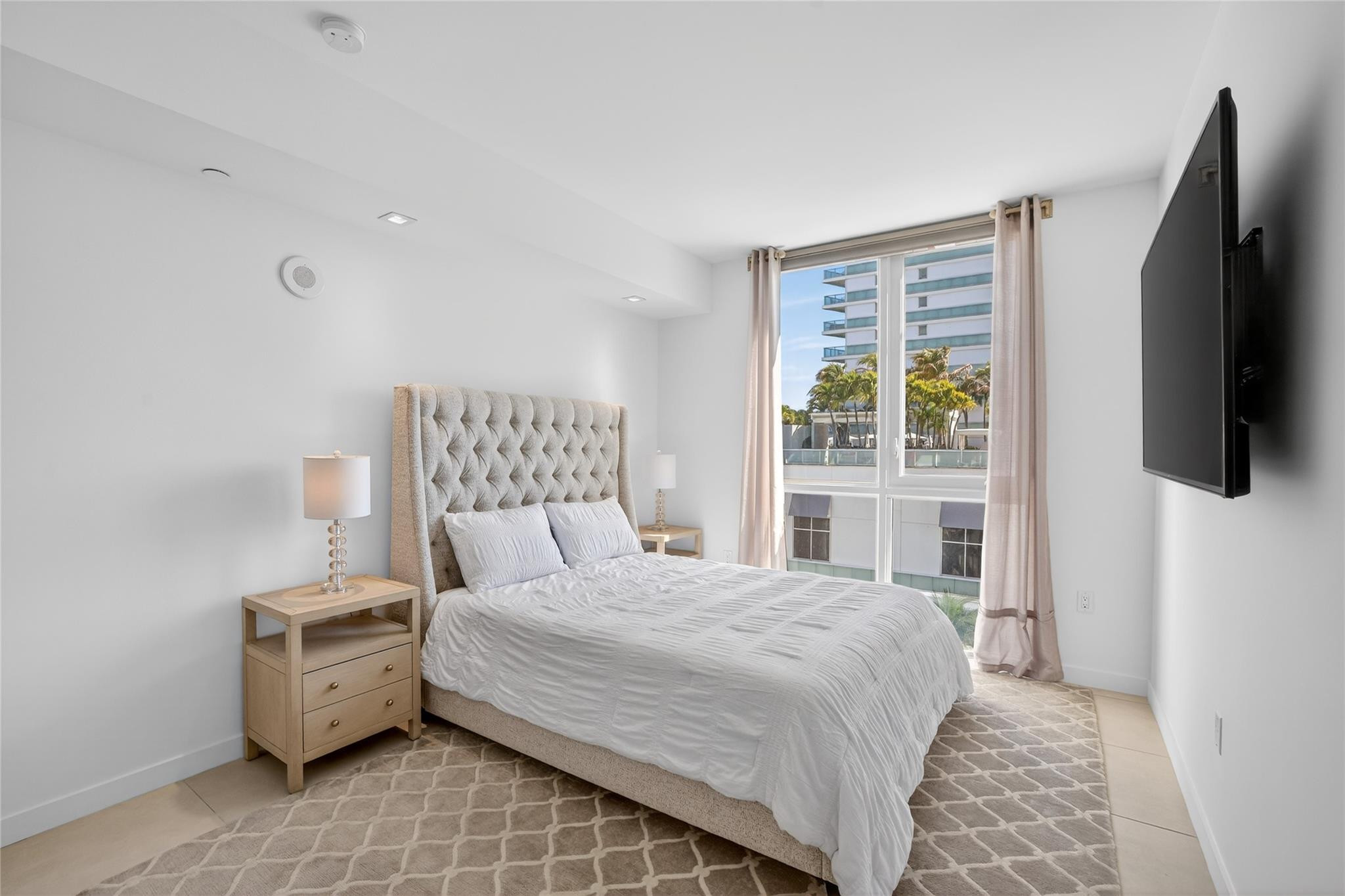 401 North Birch Road, Unit 600 Fort Lauderdale, FL 33304 - Photo 24 of 47 a bedroom with a large bed and a flat tv screen on dresser
