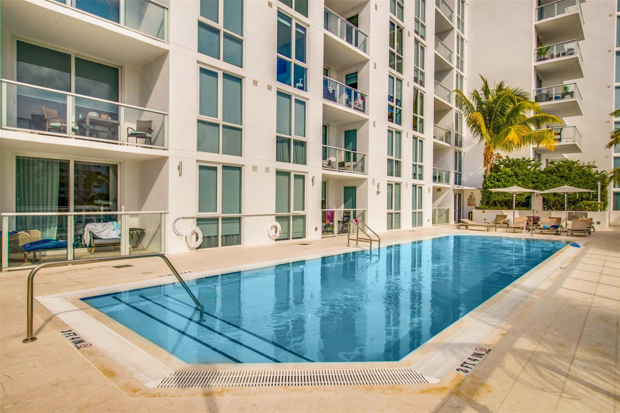 401 North Birch Road, Unit 600 Fort Lauderdale, FL 33304 - Photo 30 of 47 a view of a swimming pool with a lounge chairs