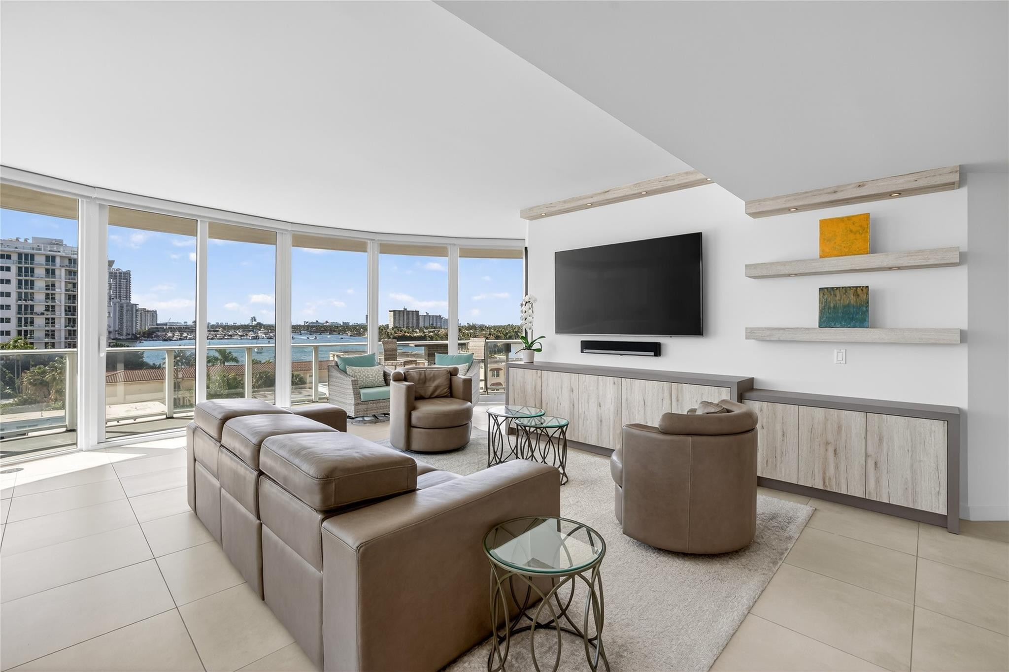 401 North Birch Road, Unit 600 Fort Lauderdale, FL 33304 - Photo 3 of 47 a living room with furniture a flat screen tv and a floor to ceiling window