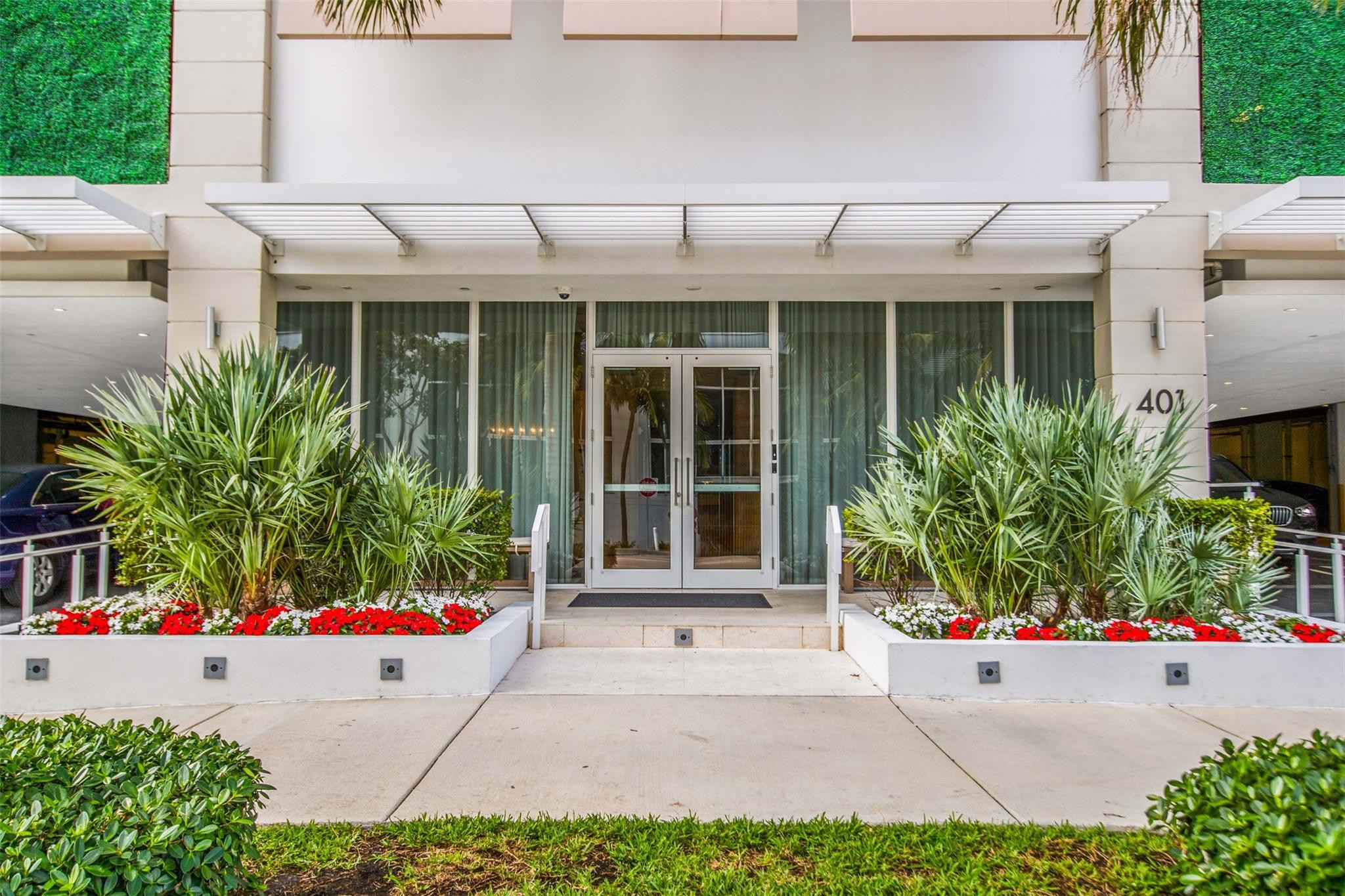 401 North Birch Road, Unit 600 Fort Lauderdale, FL 33304 - Photo 31 of 47 a view of a white house with a large window and flower plants
