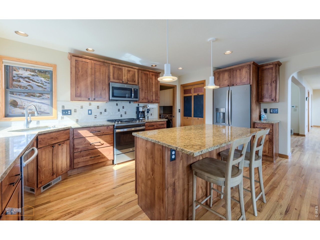 84 Canon View Road Boulder, CO 80302 - Photo 12 of 33 a kitchen with stainless steel appliances kitchen island granite countertop a table chairs sink and cabinets