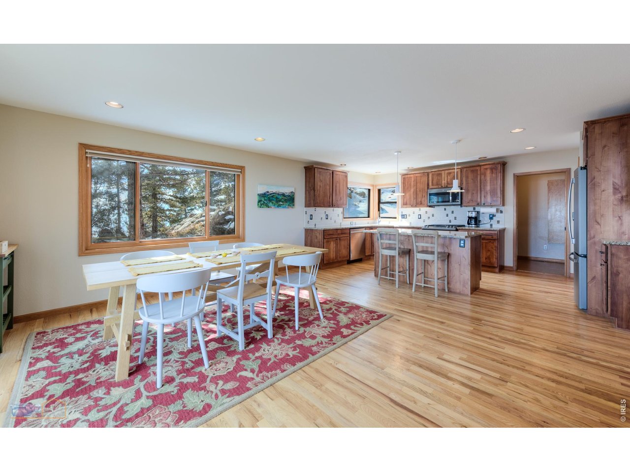 84 Canon View Road Boulder, CO 80302 - Photo 14 of 33 a living room with a dining table wooden floor and a kitchen view