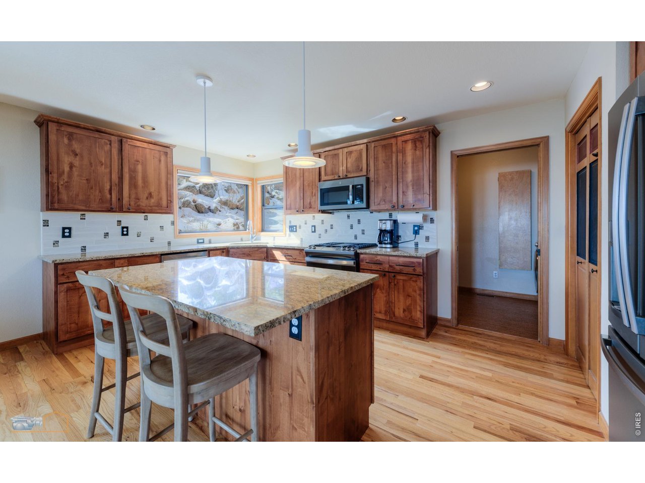 84 Canon View Road Boulder, CO 80302 - Photo 9 of 33 a kitchen with stainless steel appliances granite countertop a table chairs sink refrigerator and cabinets