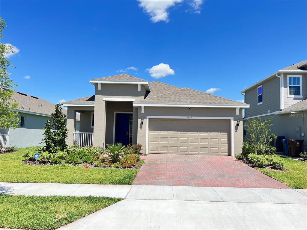 1256 Hendon Loop Davenport, FL 33837 - Photo 1 of 1 a front view of a house with garden