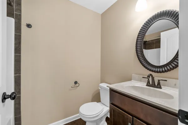 a bathroom with a sink mirror a toilet and a mirror
