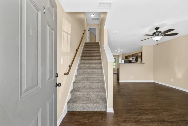 a view of an entryway with wooden floor