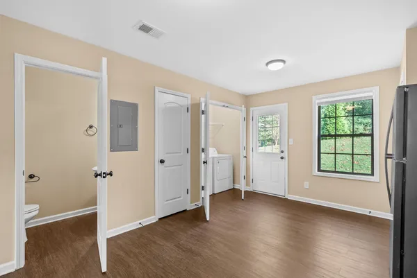 an empty room with wooden floor and a window
