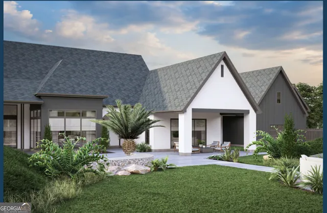 a front view of a house with a yard outdoor seating and garage