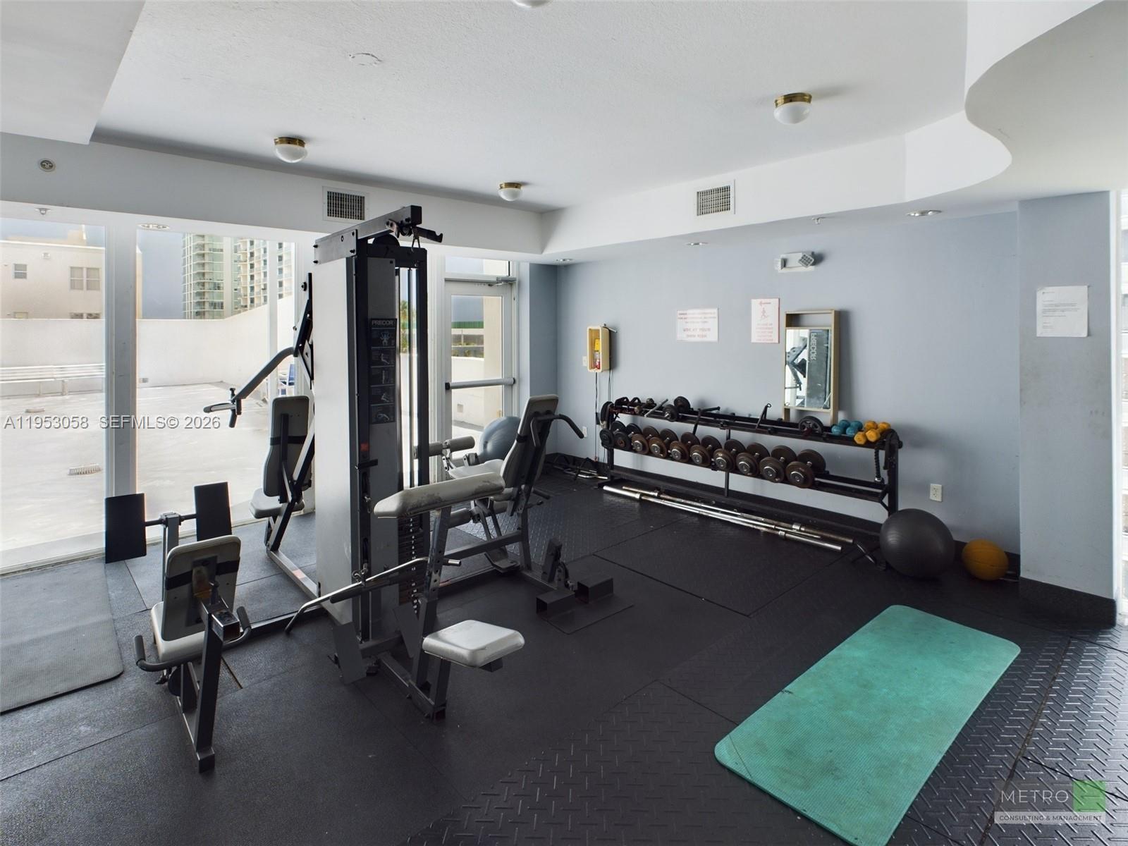 425 Northeast 30th Street, Unit 202 Miami, FL 33137 - Photo 2 of 11 a view of a room with gym equipment