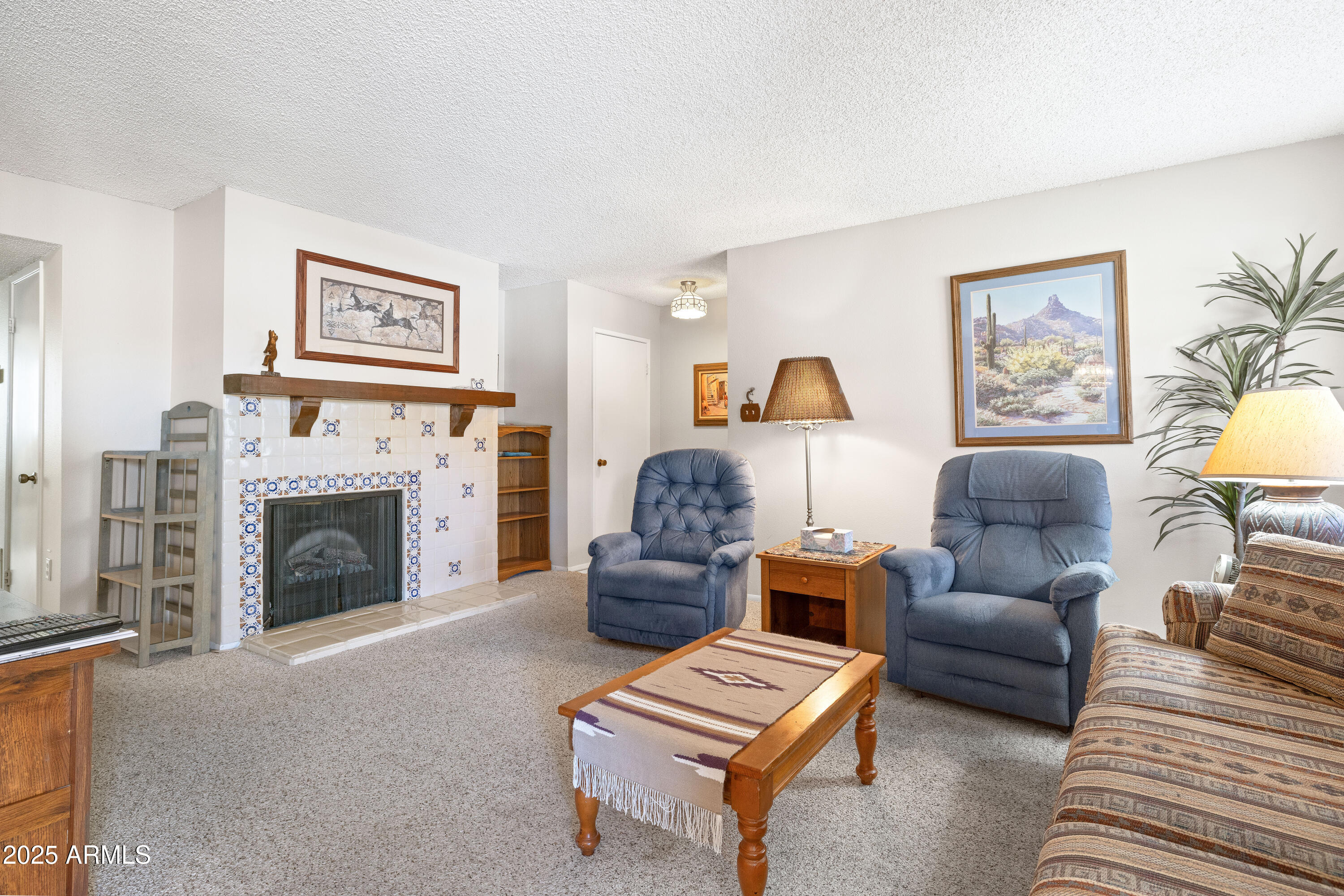 5525 East Thomas Road, Unit N5 Phoenix, AZ 85018 - Photo 1 of 27 a living room with furniture and a fireplace