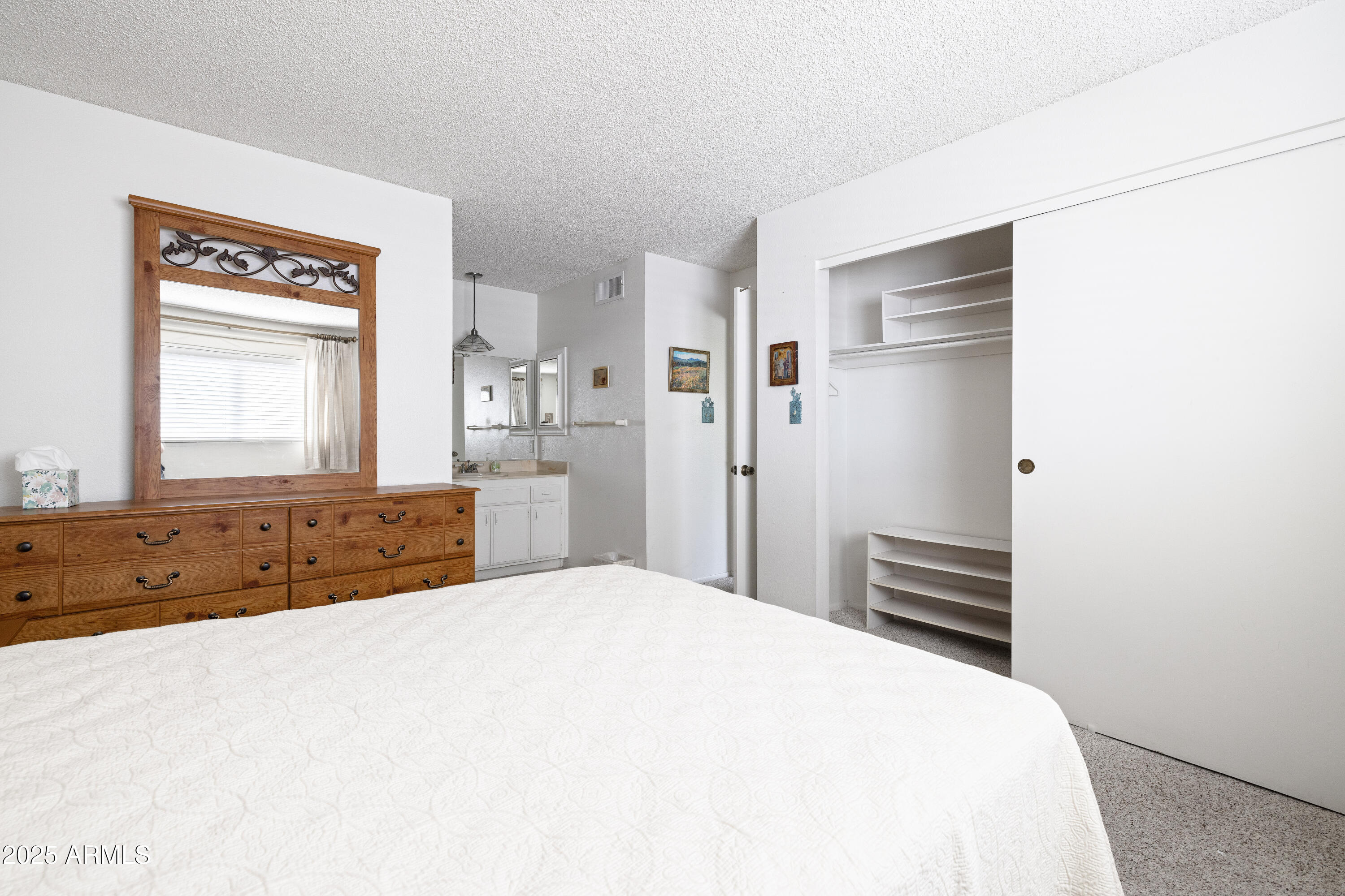 5525 East Thomas Road, Unit N5 Phoenix, AZ 85018 - Photo 10 of 27 a spacious bedroom with a bed and a dresser
