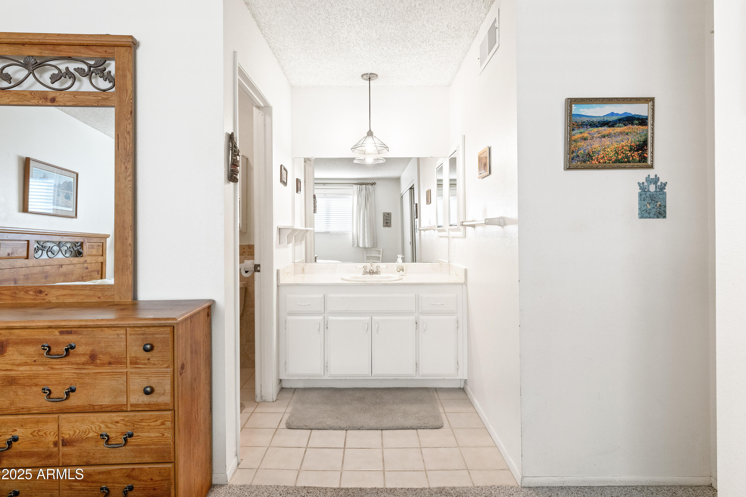 5525 East Thomas Road, Unit N5 Phoenix, AZ 85018 - Photo 12 of 27 a bathroom with a sink a vanity and a mirror