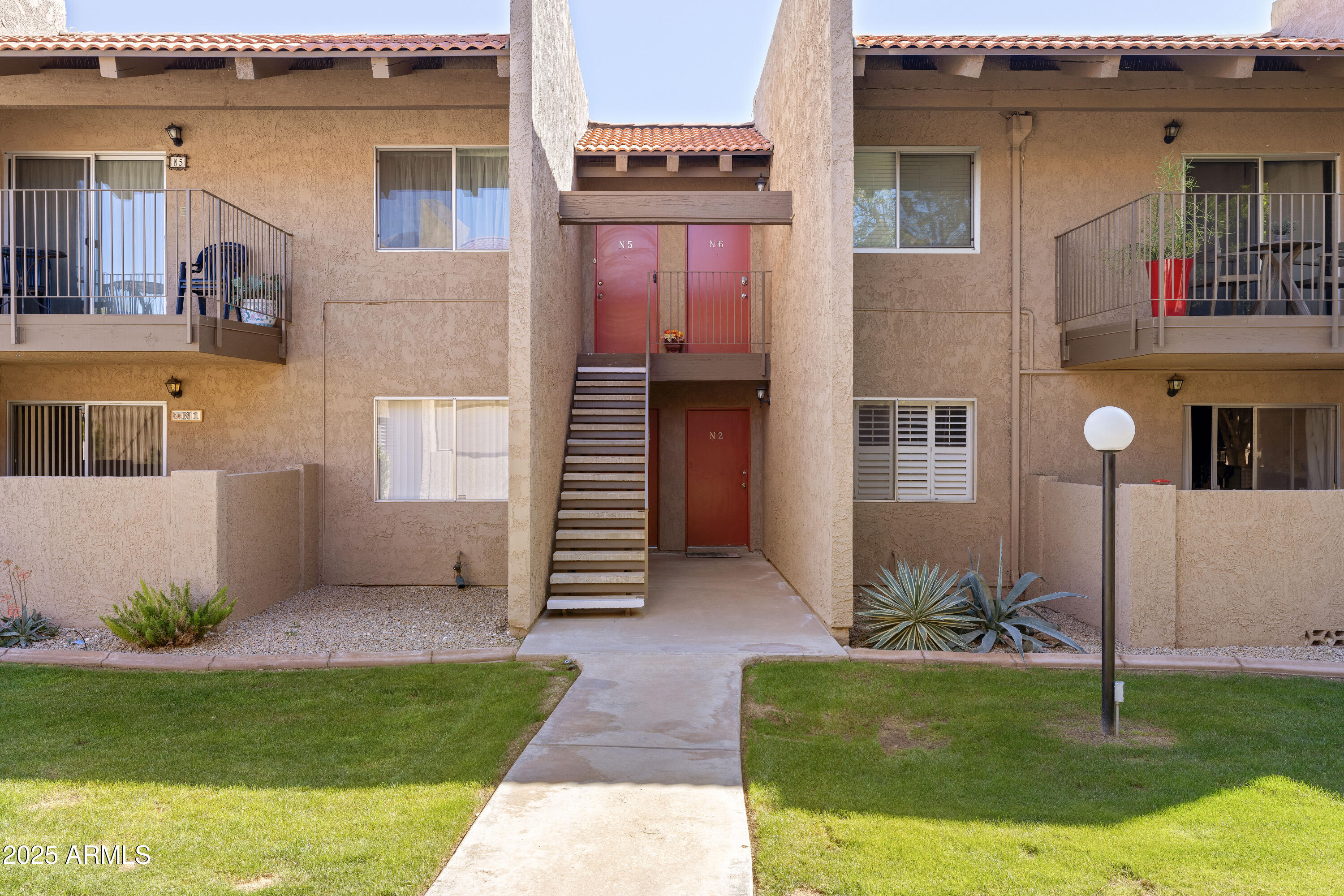 5525 East Thomas Road, Unit N5 Phoenix, AZ 85018 - Photo 17 of 27 a view of a house with a small yard and potted plants