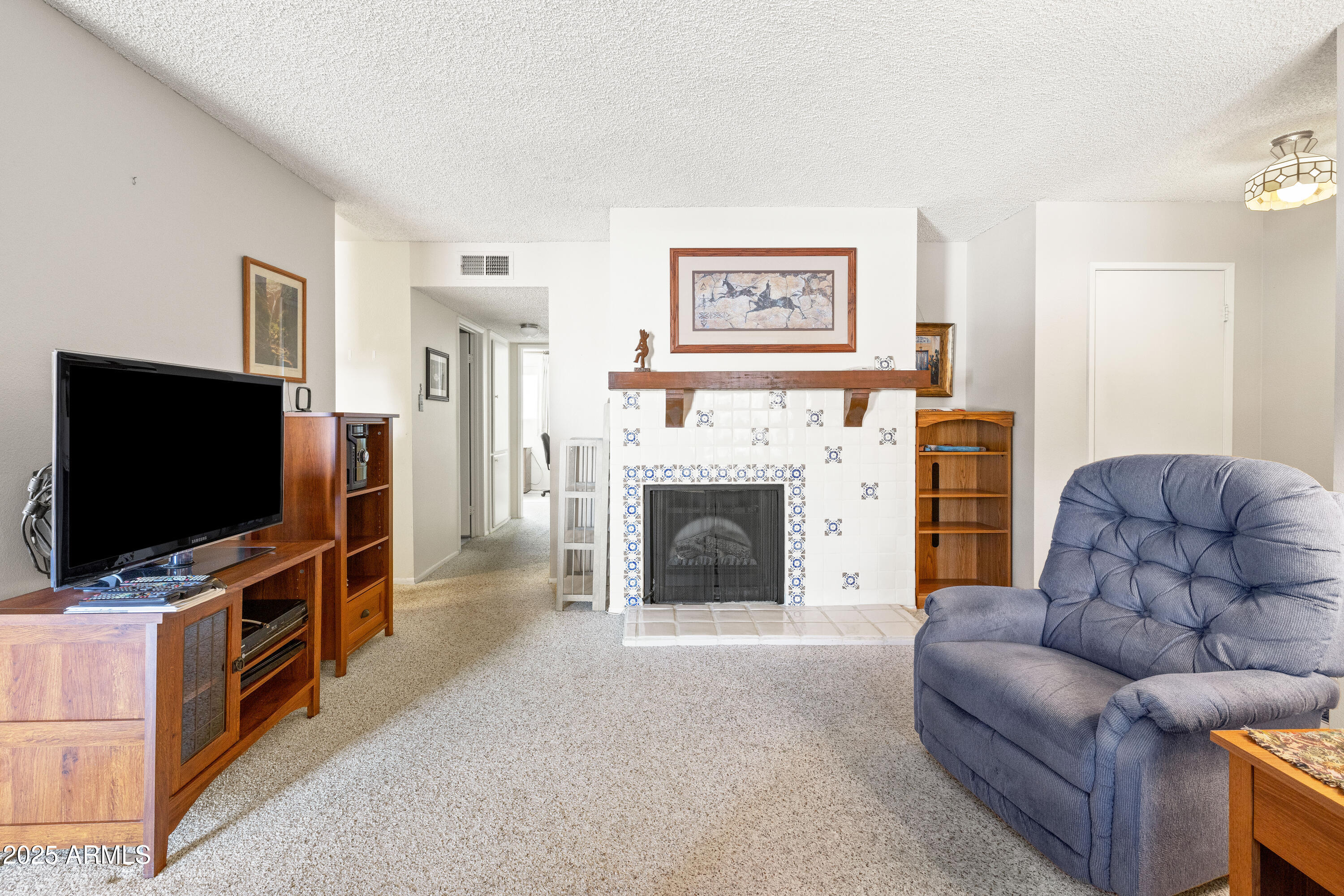 5525 East Thomas Road, Unit N5 Phoenix, AZ 85018 - Photo 2 of 27 a living room with furniture and a flat screen tv