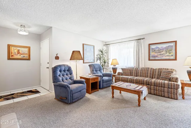 a living room with furniture fireplace and a window