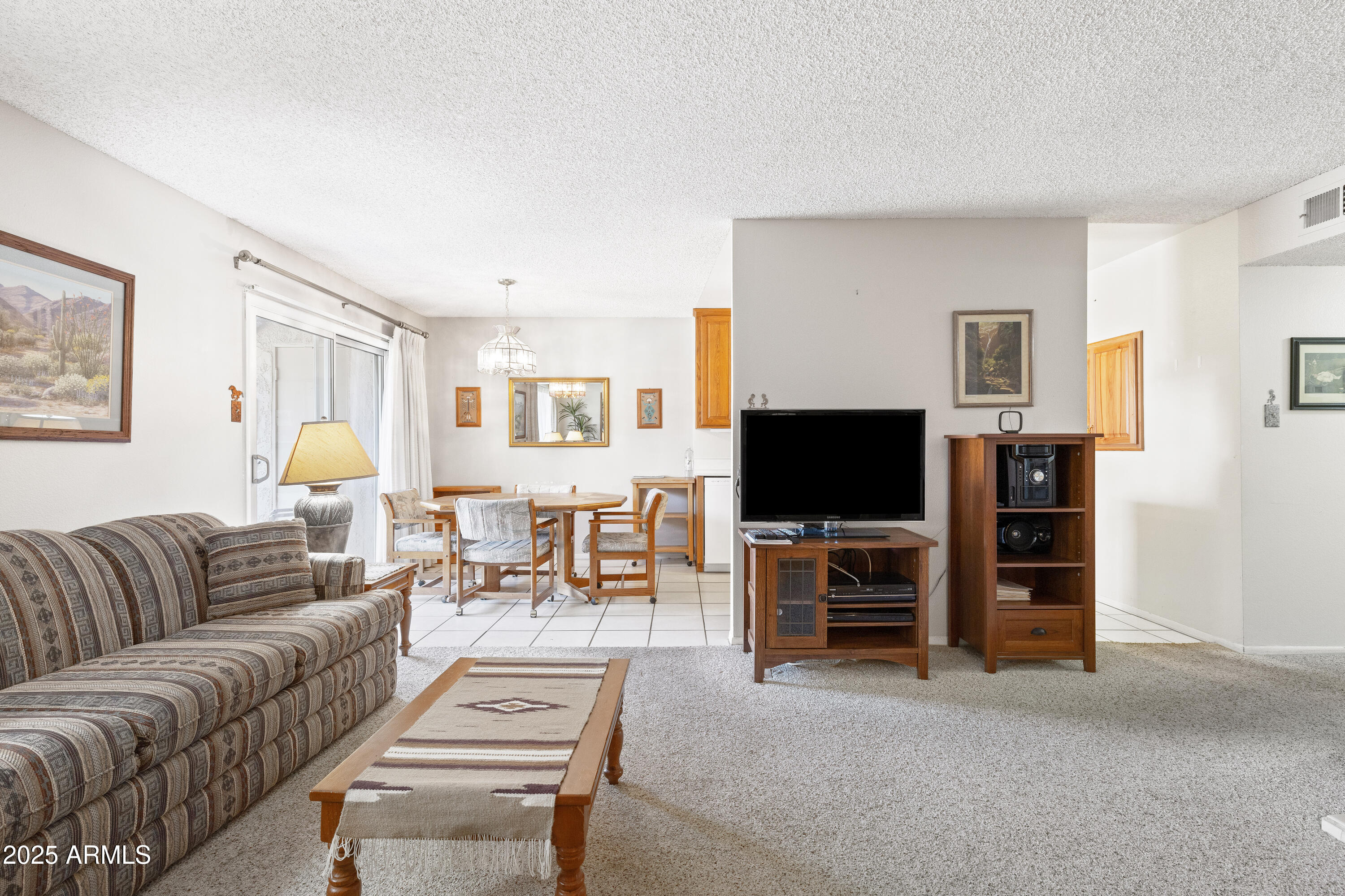 5525 East Thomas Road, Unit N5 Phoenix, AZ 85018 - Photo 5 of 27 a living room with furniture and a flat screen tv