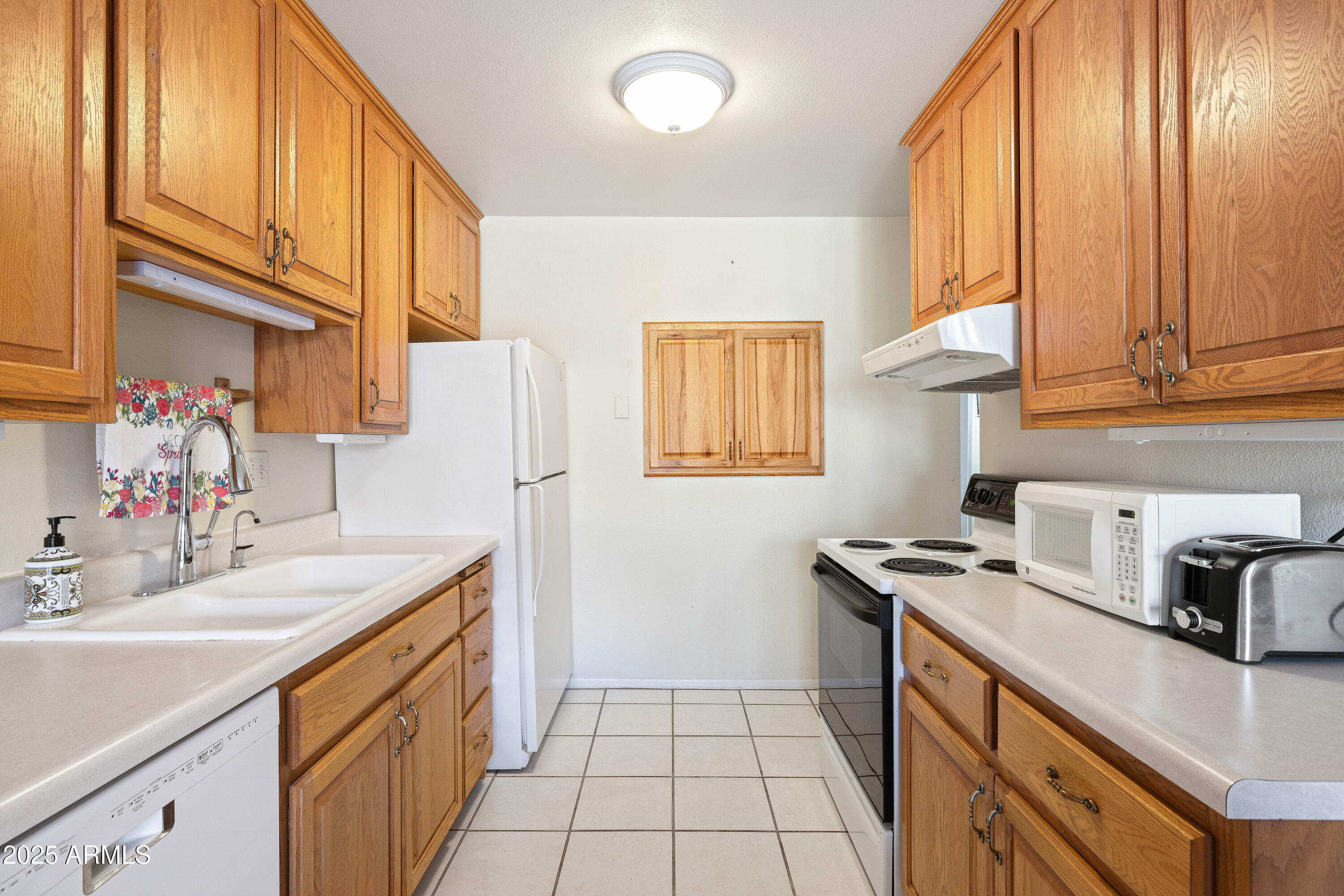 5525 East Thomas Road, Unit N5 Phoenix, AZ 85018 - Photo 6 of 27 a kitchen with a sink cabinets and a window