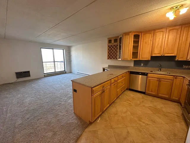 a kitchen with stainless steel appliances granite countertop a sink stove and cabinets