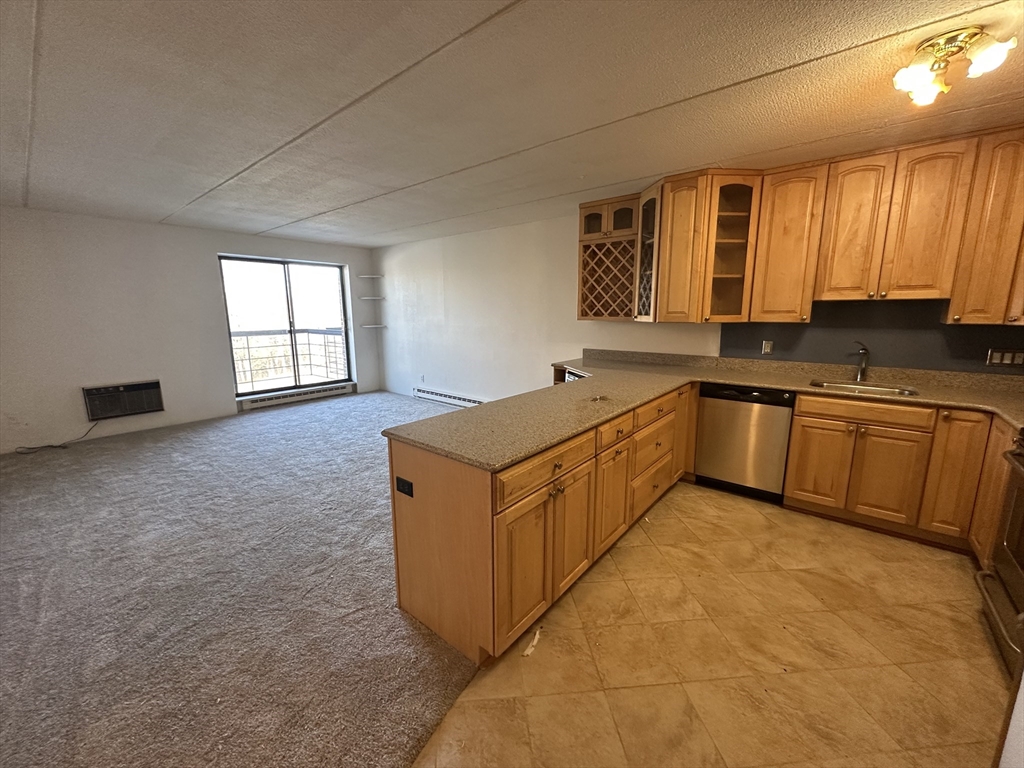 46 Cochituate Road, Unit 408 Framingham, MA 01701 - Photo 2 of 22 a kitchen with stainless steel appliances granite countertop a sink stove and cabinets