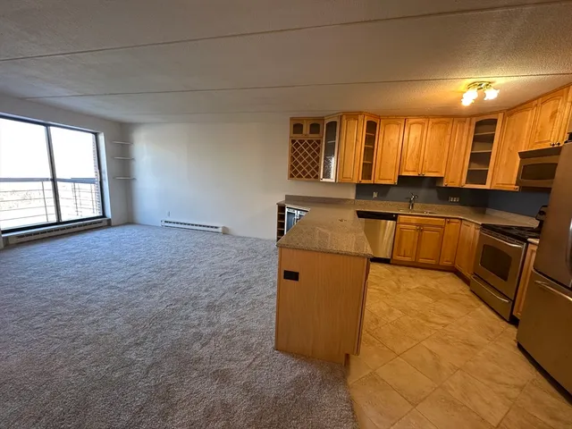 a kitchen with stainless steel appliances granite countertop a sink stove and cabinets