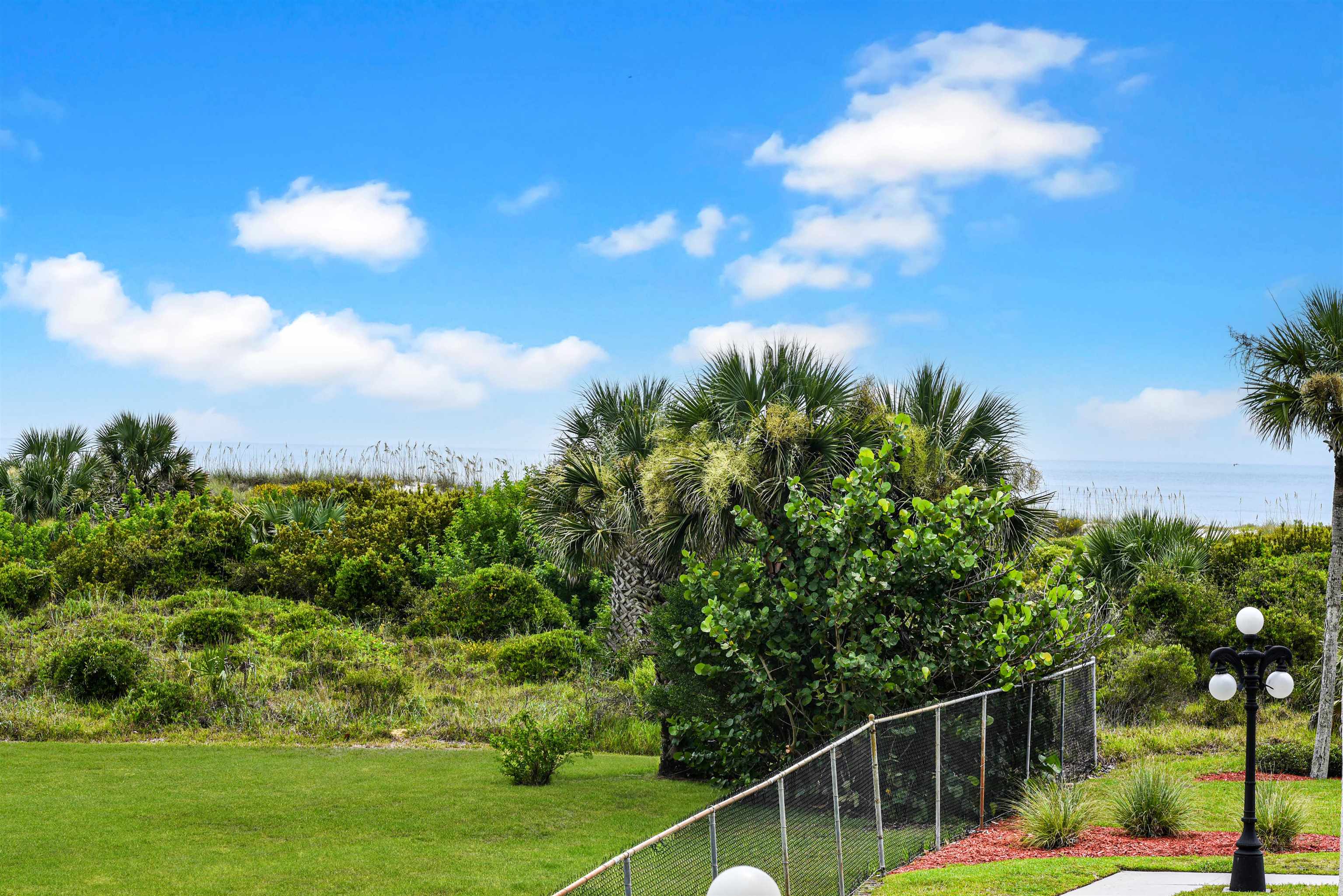2 Dondanville Road, Unit 212 St. Augustine, FL 32080 - Photo 12 of 31 a view of a yard with potted plants and sky view