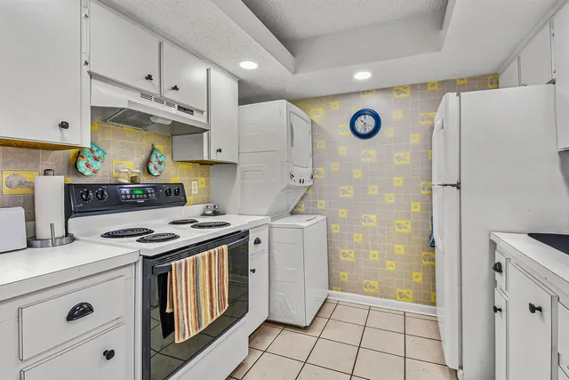 a view of a room with furniture and kitchen