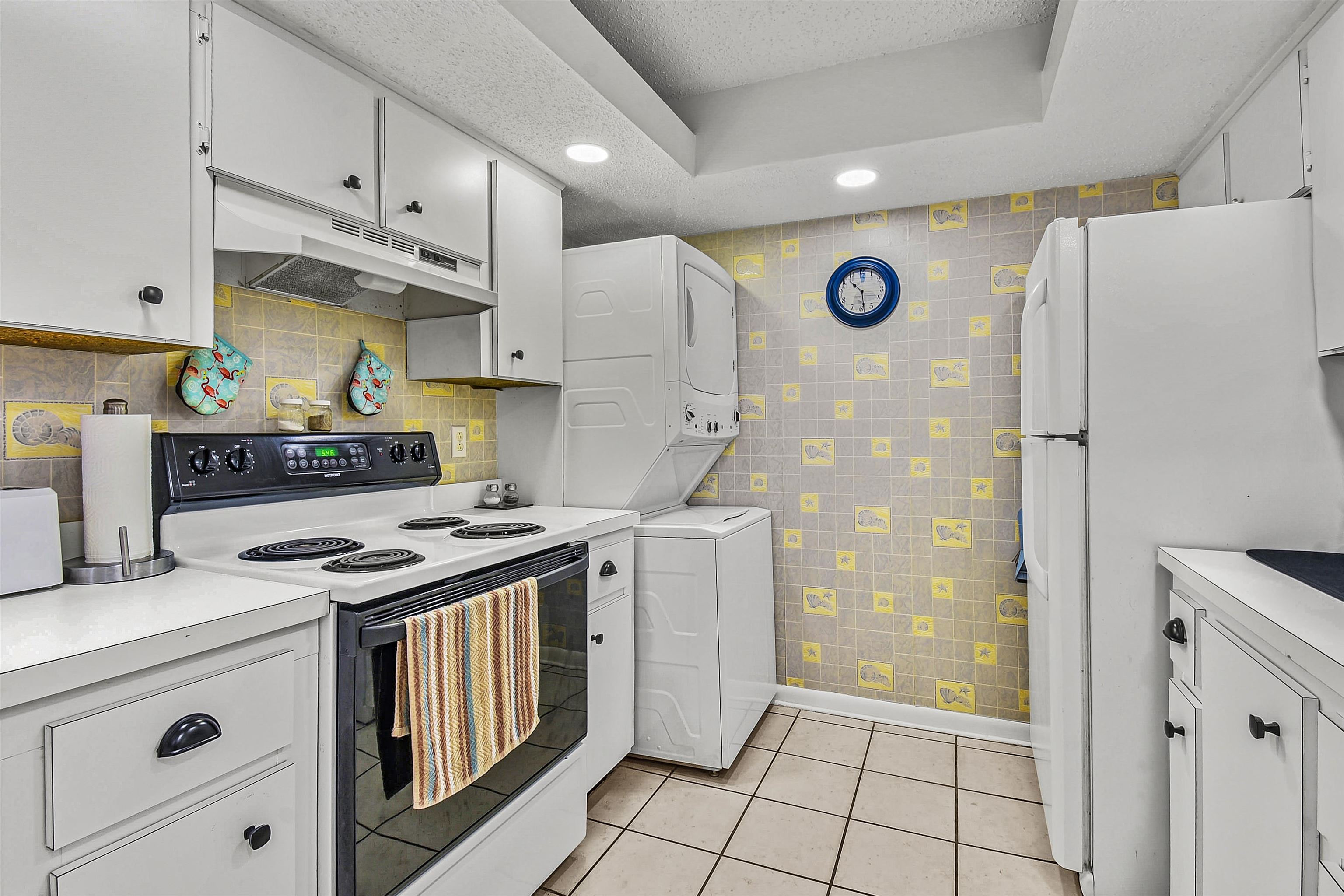 2 Dondanville Road, Unit 212 St. Augustine, FL 32080 - Photo 14 of 31 a kitchen with stainless steel appliances granite countertop a refrigerator a stove and a sink with wooden cabinets
