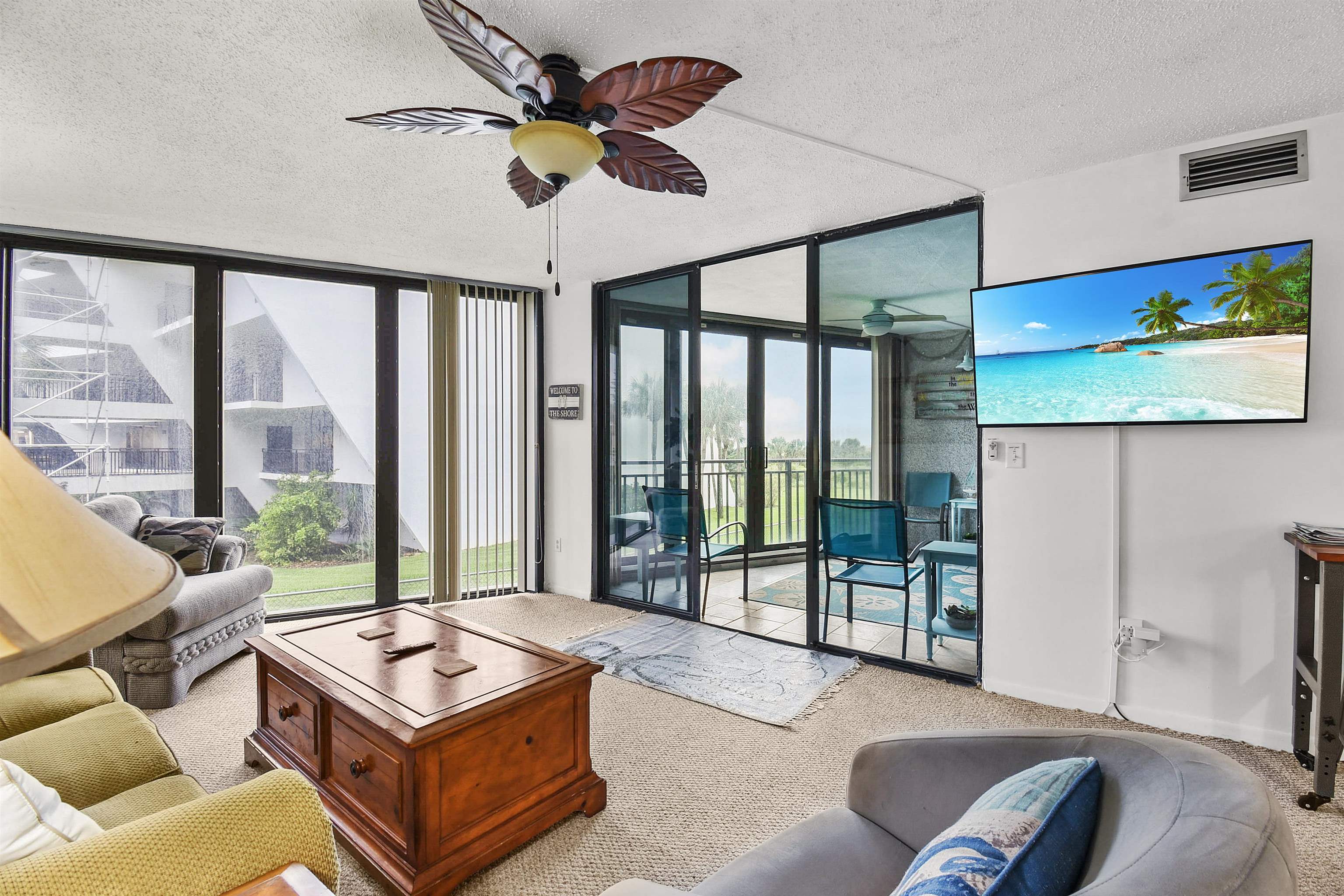 2 Dondanville Road, Unit 212 St. Augustine, FL 32080 - Photo 19 of 31 a living room with furniture floor to ceiling window and a flat screen tv