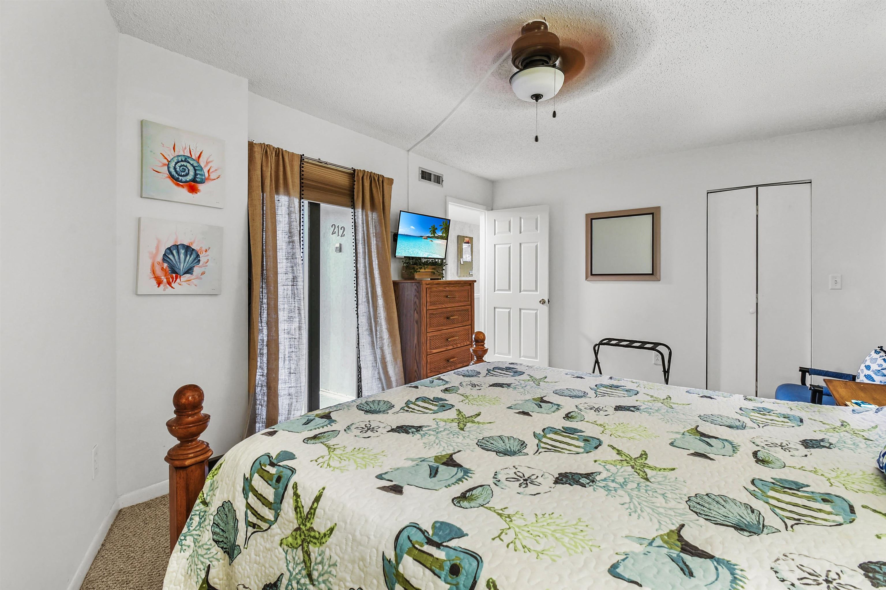 2 Dondanville Road, Unit 212 St. Augustine, FL 32080 - Photo 23 of 31 a bedroom with a bed and a dresser in it