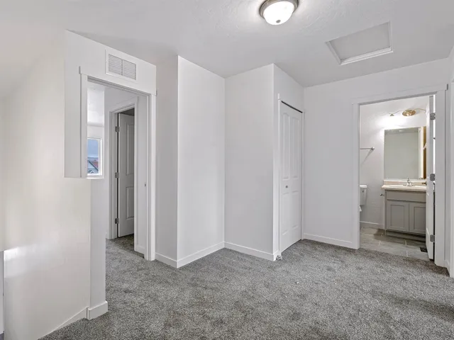a view of a room with a sink and a mirror