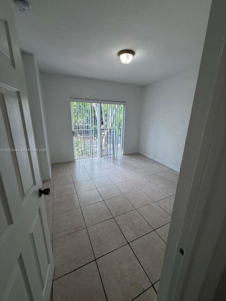681 Southwest 7th Street, Unit 681 Florida City, FL 33034 - Photo 7 of 16 a view of an empty room with windows