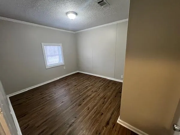 a view of room with wooden floor and window