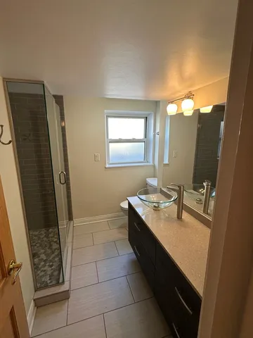 a bathroom with a sink a toilet and a mirror