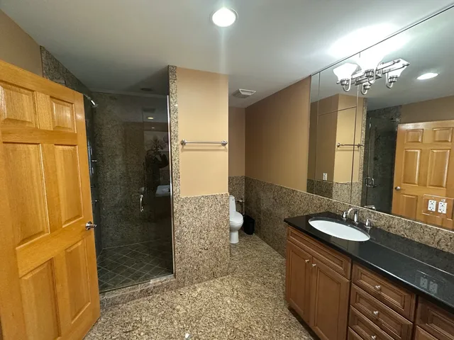 a bathroom with a double vanity sink a mirror and a shower