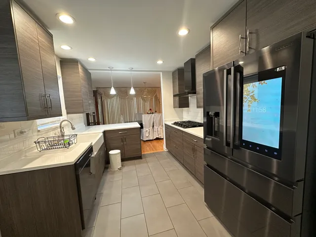 a large kitchen with a large counter top appliances and cabinets