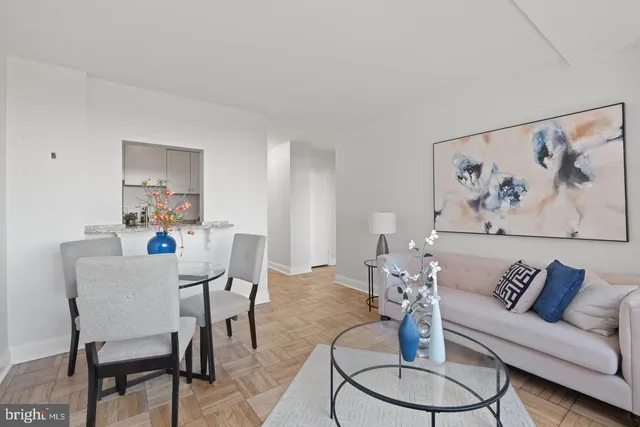 a living room with furniture and a dining table