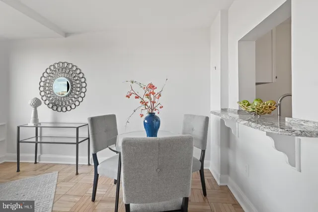 a dining room with furniture and wooden floor
