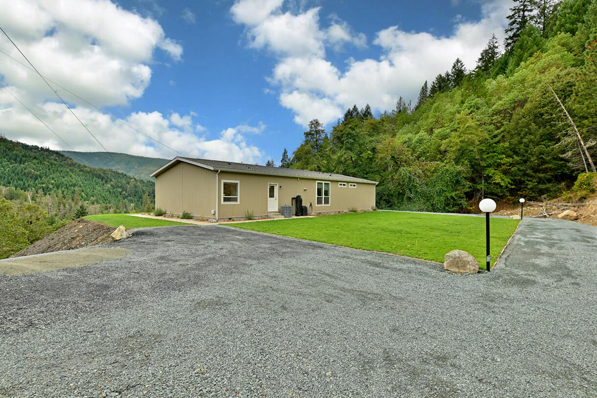 5572 Jumpoff Joe Creek Road Grants Pass, OR 97526 - Photo 34 of 38 a view of a house with a backyard