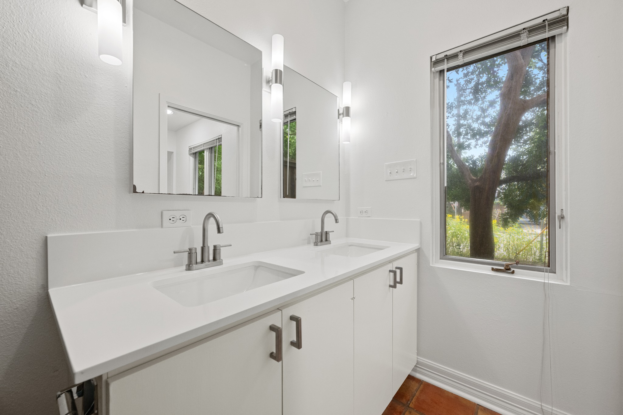 409 East 38th Street, Unit 101 Austin, TX 78705 - Photo 14 of 27 New Dual vanities with modern fixtures and wonderful natural light.