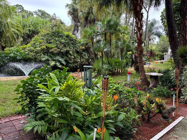 a backyard of a house with lots of green space and trees all around